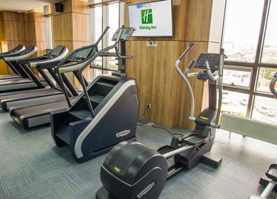 Modern gym equipment at Wellness Center in Ulaanbaatar, Ulaanbaatar, MN, featuring treadmills and ellipticals.