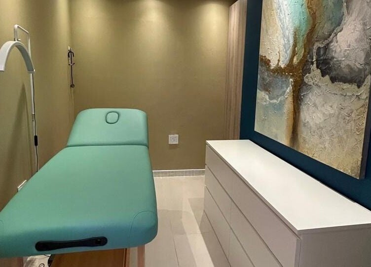 Peaceful treatment room at MorrowMed, Ballito, Kwazulu-natal, ZA, featuring a teal massage bed and calming decor.