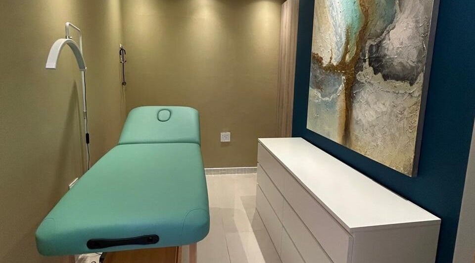 Peaceful treatment room at MorrowMed, Ballito, Kwazulu-natal, ZA, featuring a teal massage bed and calming decor.