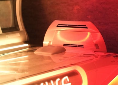 Modern tanning bed at Natural Bronze Tanning Salon, Braunton, England, GB, glowing in warm, inviting light.