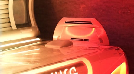 Modern tanning bed at Natural Bronze Tanning Salon, Braunton, England, GB, glowing in warm, inviting light.