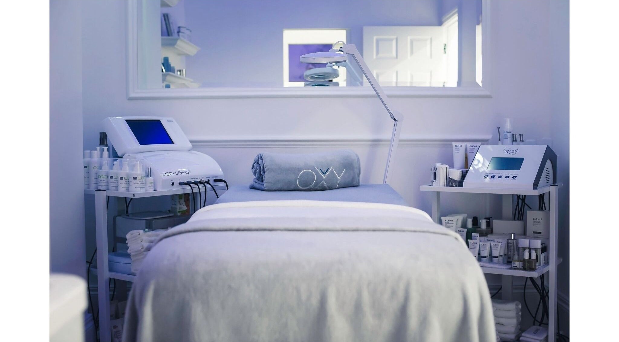 Oxy Spa LTD treatment room in London, England, GB, with advanced skincare equipment and delicate lighting.