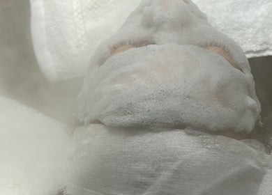 Luxurious facial treatment with foam mask at Luxe Mere’, London, England, GB, offering relaxation and rejuvenation.