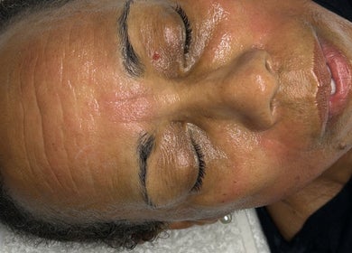 Relaxing facial treatment in progress at Luxe Mere’, London, England, GB showcasing glowing, rejuvenated skin.