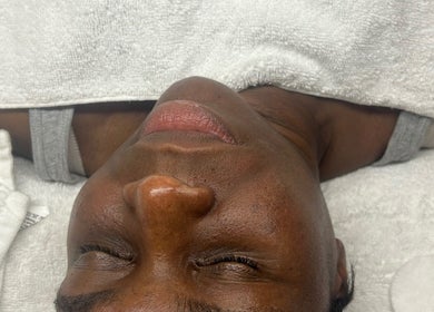 Facial treatment at Luxe Mere’, London, England, GB showcasing a relaxed client on a plush towel.