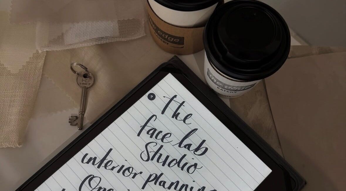 Notebook and coffee on a table at Just Jess, Witney, England, GB, showcasing creative interior plans.