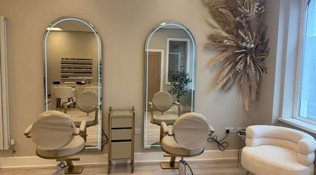 Elegant interior of Nails & Beauty by Lucy in Ramey, IM, featuring modern styling chairs and mirrors.