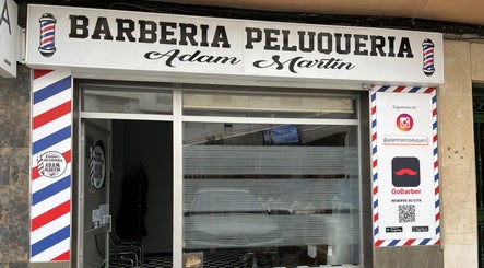 Entrada de Barberia Adam Martin en Castell De Ferro, Andalucía, ES, con logotipo distintivo.