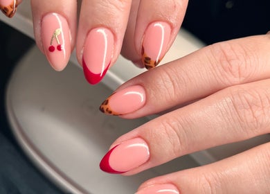 Nail art with cherry design and leopard tips at Freyasbeautybar, Caterham, England, GB.