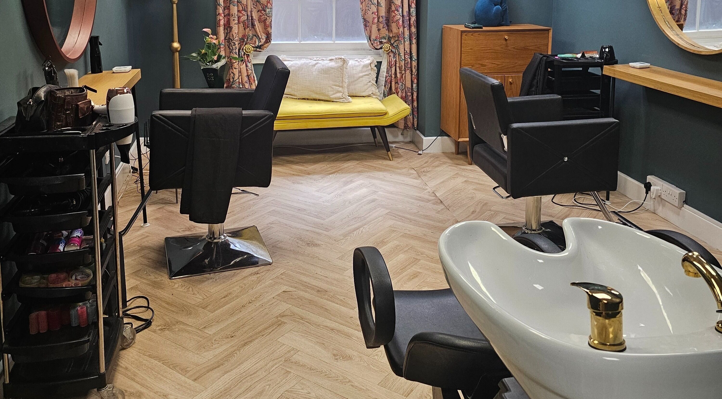 Elegant salon interior at Jolie Hairdressing in London, England, GB with chic decor and comfortable seating.
