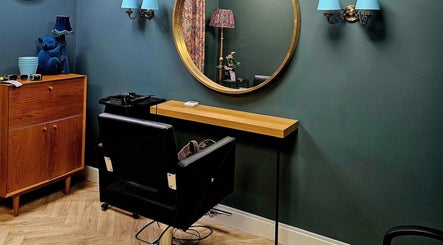 Jolie Hairdressing salon station with mirror, chair, and decor in London, England, GB reflects chic styling.