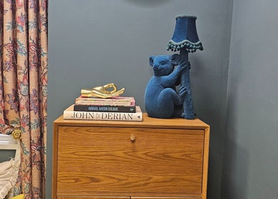 Elegant corner at Jolie Hairdressing, London, England, GB, featuring a playful koala lamp and floral curtains.