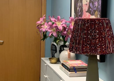 Cozy interior of Jolie Hairdressing in London, England, featuring elegant decor with flowers and a patterned lamp.