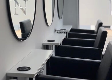 Elegant salon chairs and mirrors at Beloved Locks Hair in Alton, England, GB.