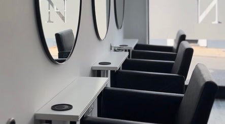 Elegant salon chairs and mirrors at Beloved Locks Hair in Alton, England, GB.