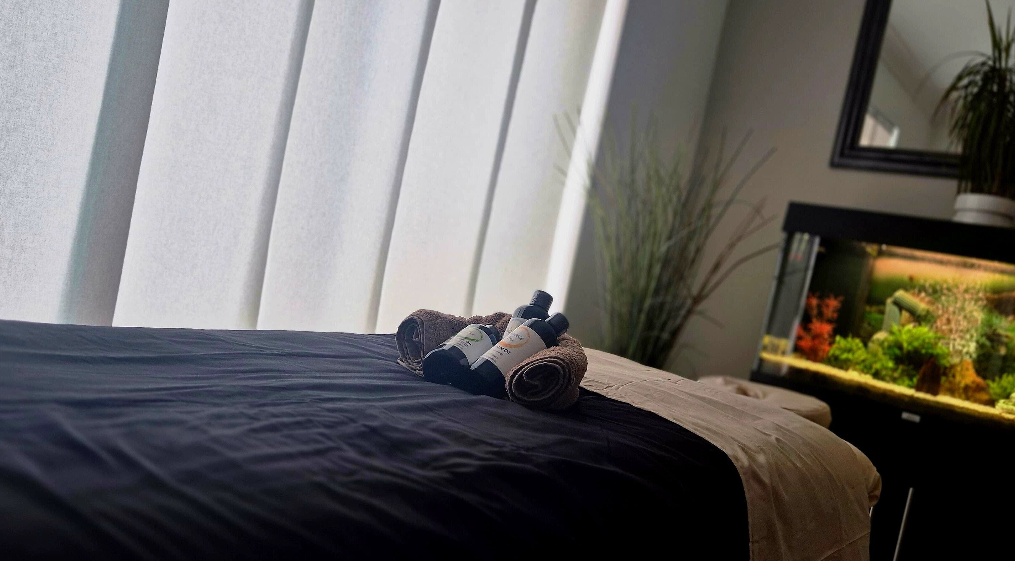 Massage table with oils at Still Waters MK, Tattenhoe Park, England, GB, offering calm and relaxation.