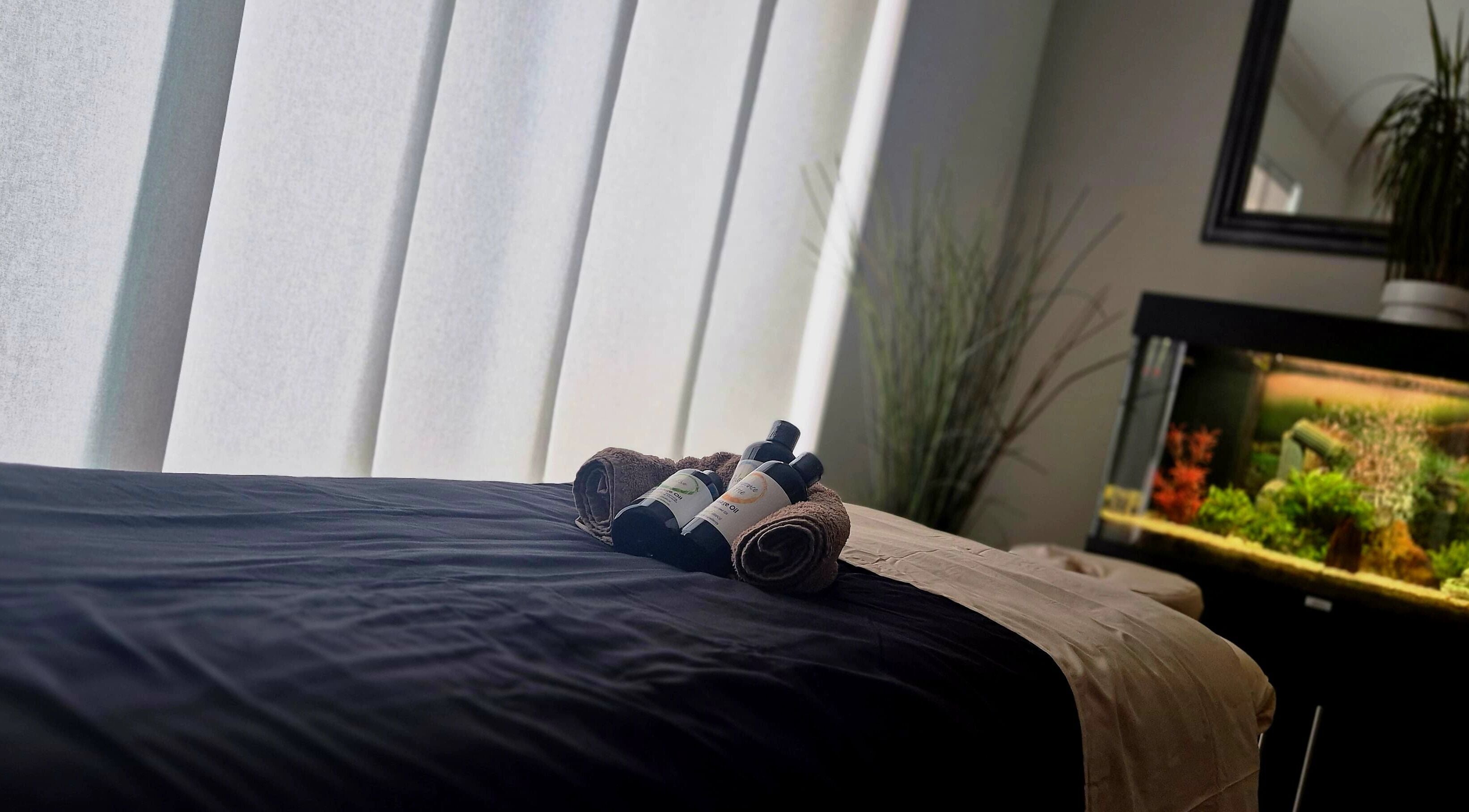 Massage table with oils at Still Waters MK, Tattenhoe Park, England, GB, offering calm and relaxation.