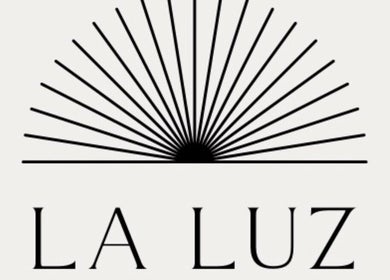 Logo of La Luz Beauty Studio, located in Saint Michael, BB, featuring a sunburst design.