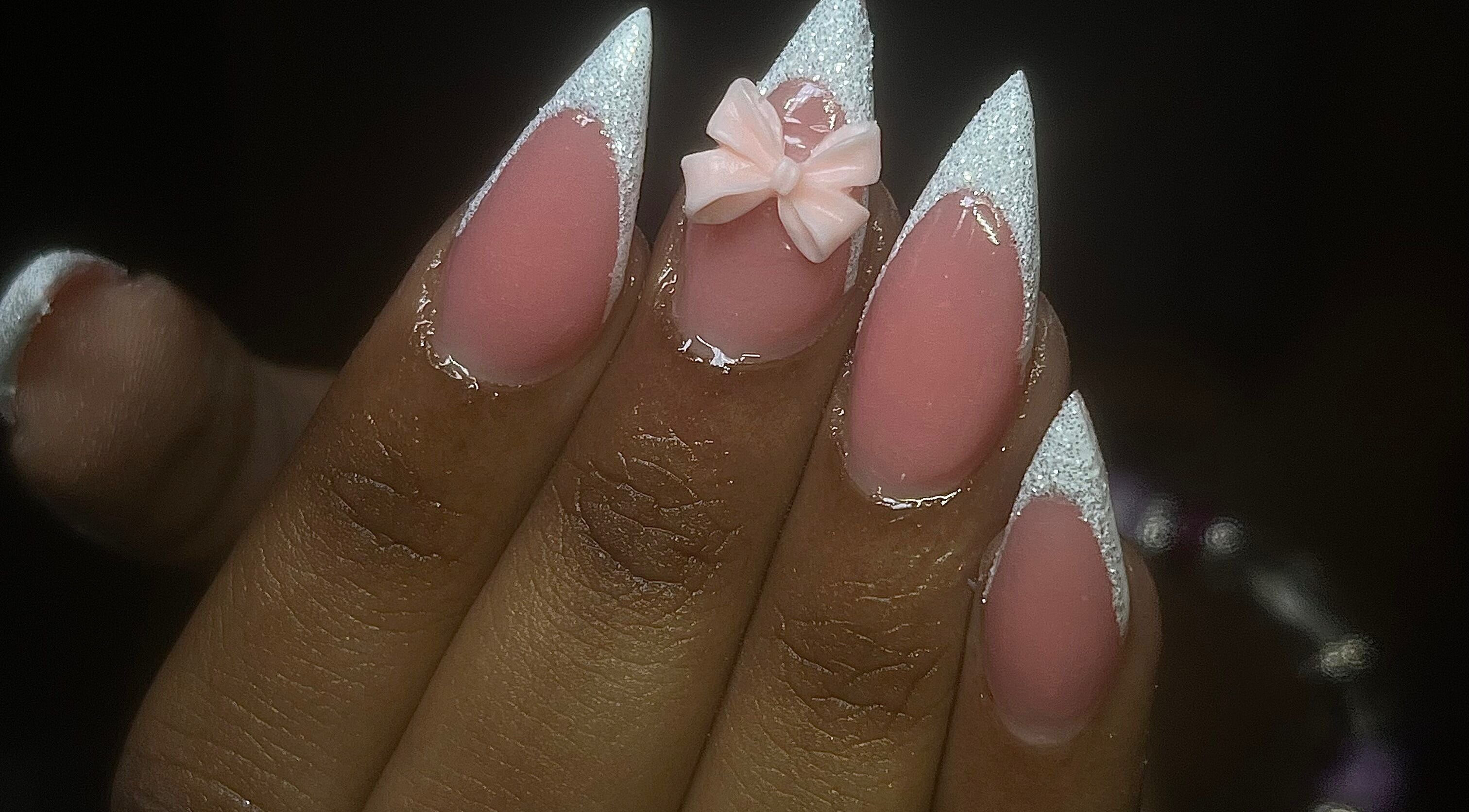 Stylish pink nails with glitter tips and a bow at La Luz Beauty Studio, Saint Michael, Saint Michael, BB.