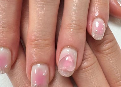 Elegant pink nail art with heart accents at Tokyo Nailya in London, England, GB.