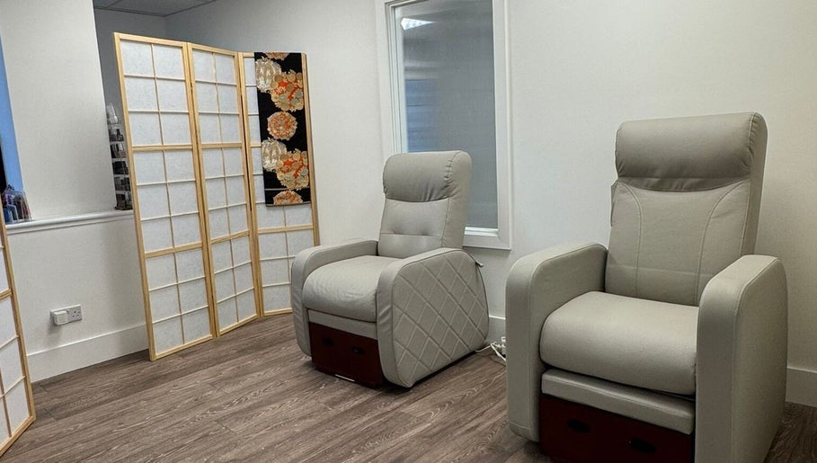 Relaxing seating area at Tokyo Nailya, London, England, GB, featuring plush chairs and elegant decor.