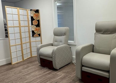 Relaxing seating area at Tokyo Nailya, London, England, GB, featuring plush chairs and elegant decor.