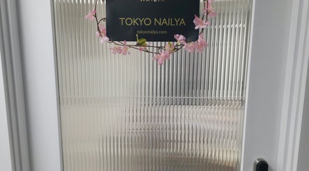 Entrance sign of Tokyo Nailya with floral decor, located in London, England, GB.