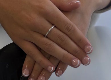 Freshly manicured hands with French tips at The Luxe Lounge Lash & Brows in Cardiff, Wales, GB.