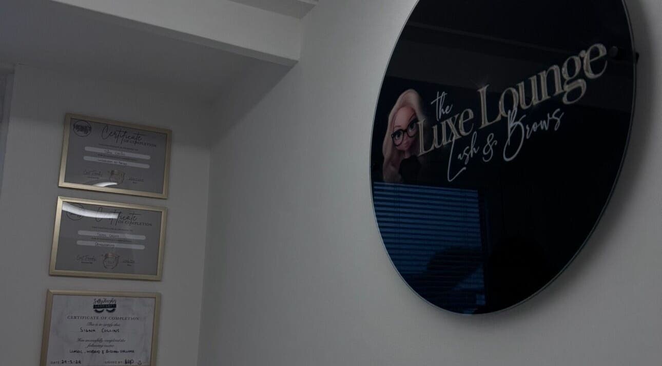 Interior of The Luxe Lounge Lash & Brows, Cardiff, UK, showcasing accolade certificates on a modern wall.