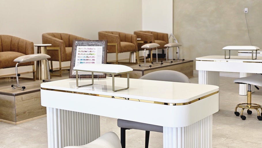Elegant nail salon setup at Honey Bunny, St. Catharines, Ontario, CA with seating and polish display.