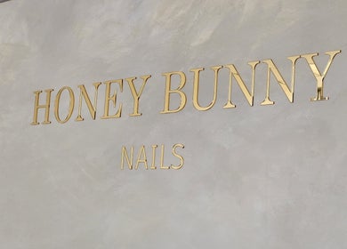 Honey Bunny Nails elegant gold signage in St. Catharines, Ontario, CA, showcasing modern aesthetics.