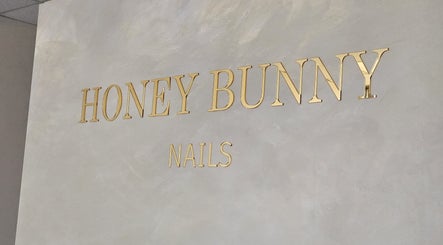Honey Bunny Nails elegant gold signage in St. Catharines, Ontario, CA, showcasing modern aesthetics.
