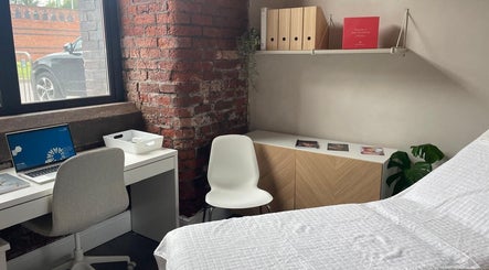 Modern treatment room at Transfigure Medical Aesthetics, Stockport, England, GB with stylish decor.