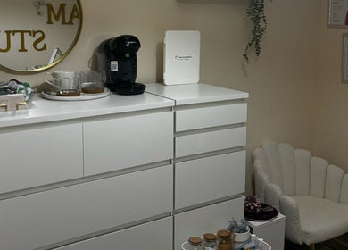 Cozy beauty corner at By.vestajonkute in Liverpool, England, GB with modern white drawers and comfortable chair.