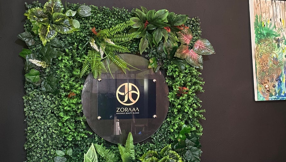 Zoraaa Maximus Beauty Klinik signage surrounded by lush greenery, located in Knockpatrick, Manchester Parish, JM.