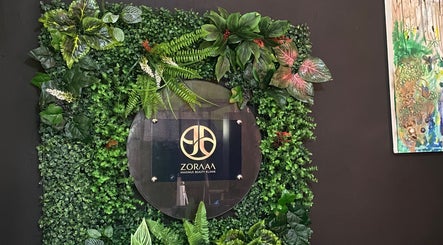 Zoraaa Maximus Beauty Klinik signage surrounded by lush greenery, located in Knockpatrick, Manchester Parish, JM.