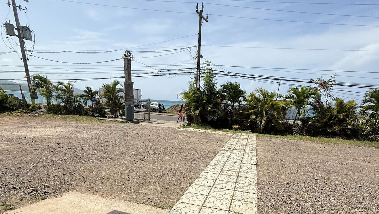 Entrance view at Metcalfe Medical Centre Limited, Port Maria, St. Mary Parish, JM with ocean backdrop.