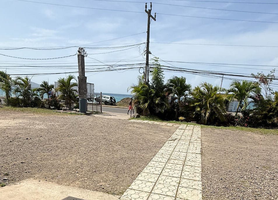 Entrance view at Metcalfe Medical Centre Limited, Port Maria, St. Mary Parish, JM with ocean backdrop.