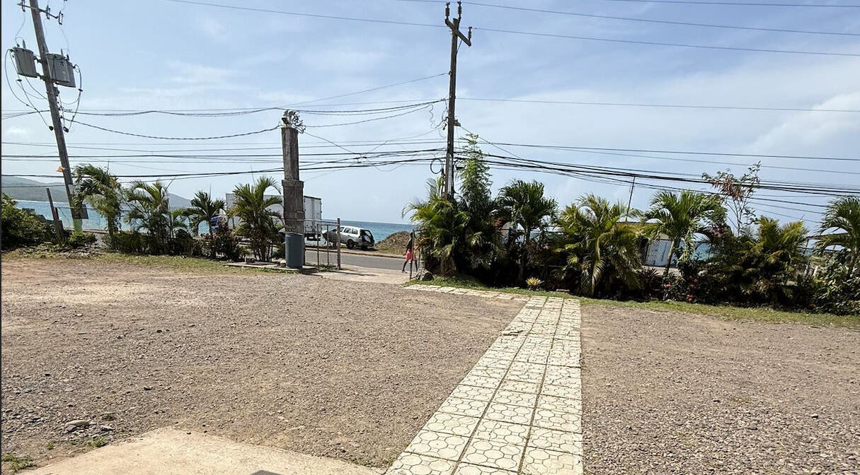 Entrance view at Metcalfe Medical Centre Limited, Port Maria, St. Mary Parish, JM with ocean backdrop.