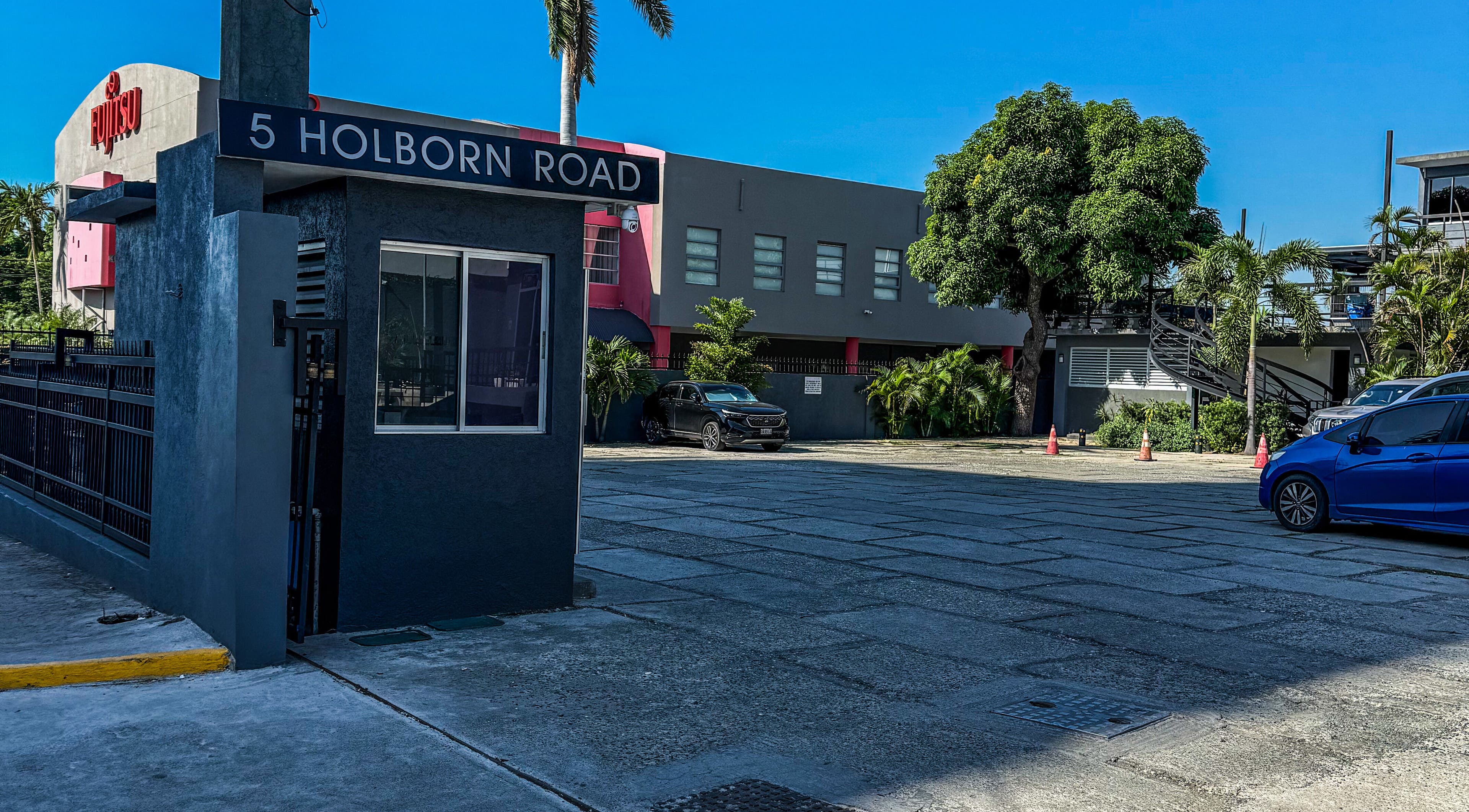 Entrance to Dr. Ruddock Dermatology at 5 Holborn Road, Kingston, St. Andrew Parish, JM, with parking area.