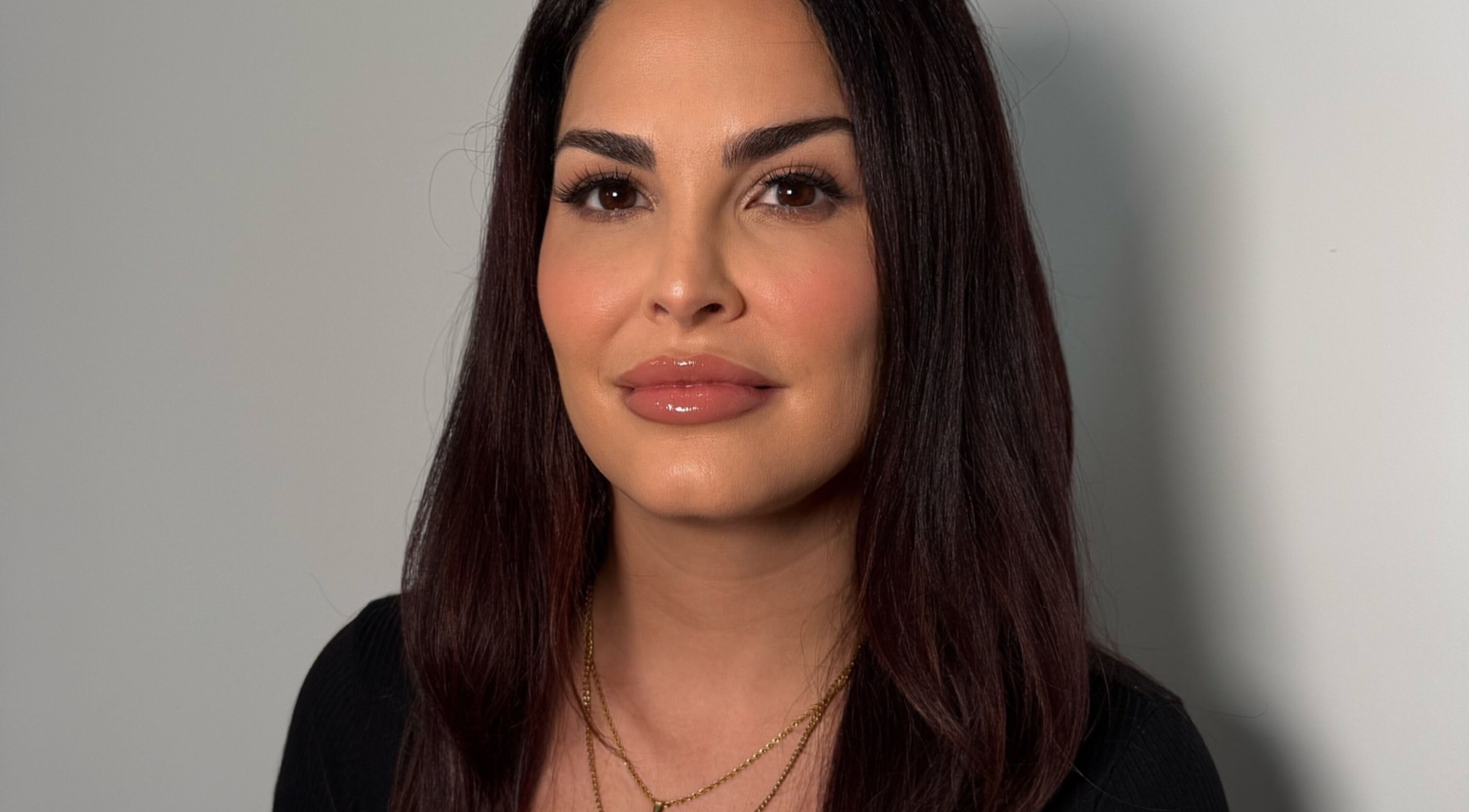 A person with a polished appearance at Valore Beauty in Barrie, Ontario, CA, showcasing elegance and expertise.