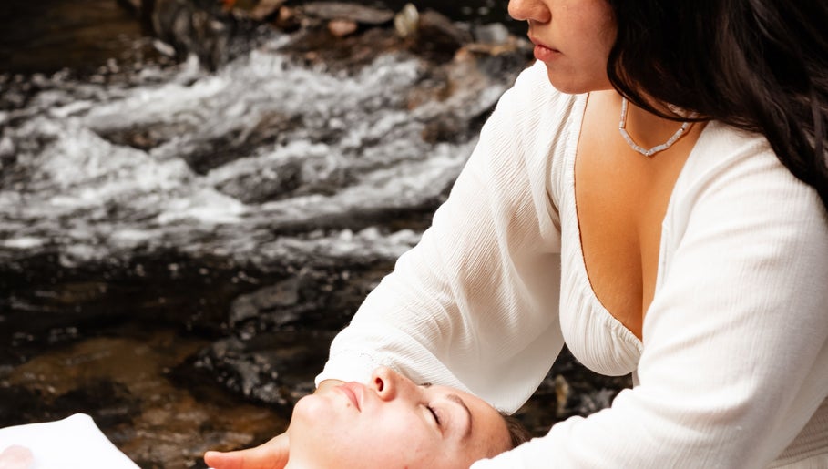 Relaxing outdoor massage at LGHTTouch in Philadelphia, Pennsylvania, US, beside a tranquil river setting.