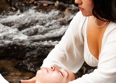Relaxing outdoor massage at LGHTTouch in Philadelphia, Pennsylvania, US, beside a tranquil river setting.