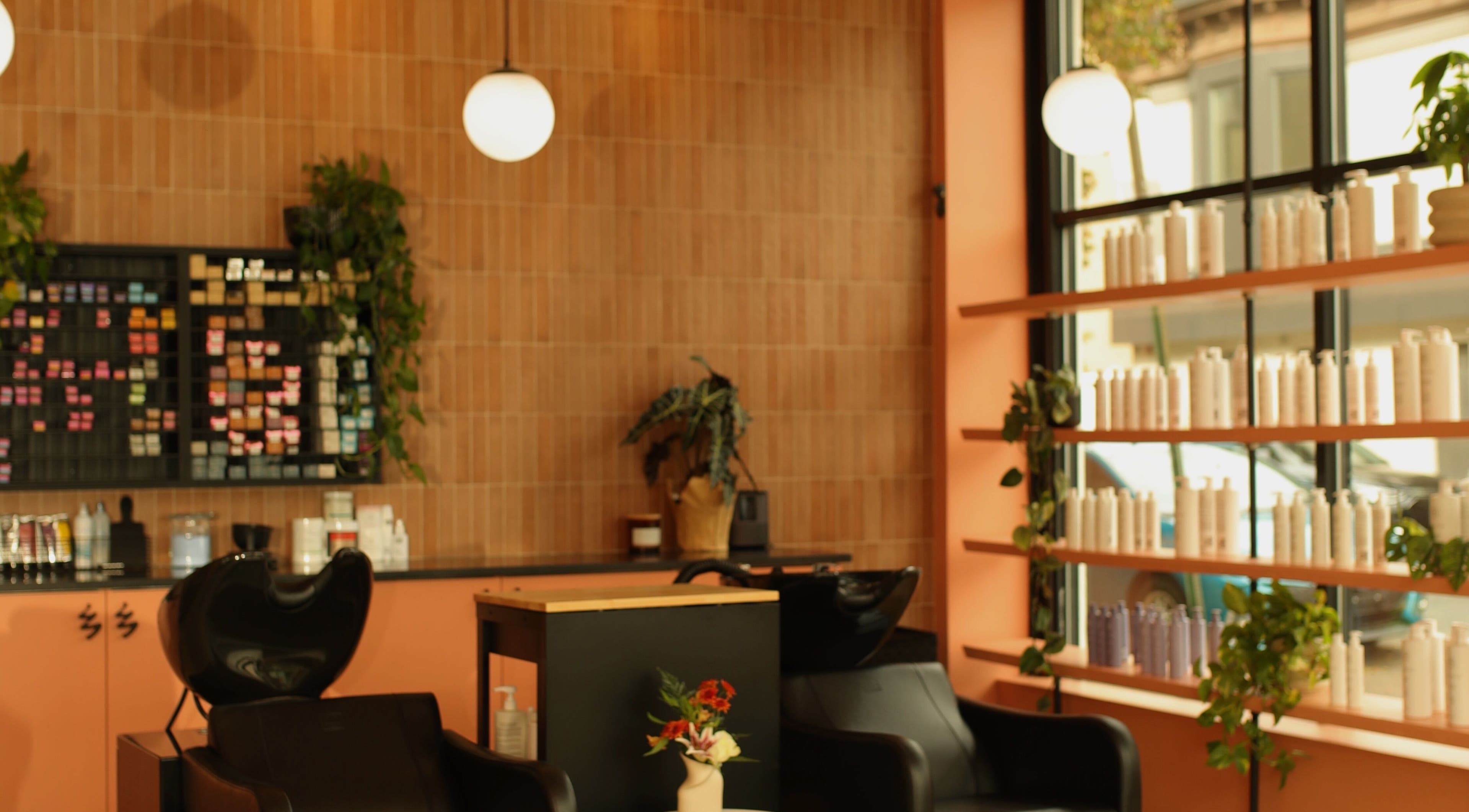 Interior of LGHTTouch Pop-Up at Wash~Day in Philadelphia, Pennsylvania, US, featuring modern design and product shelves.