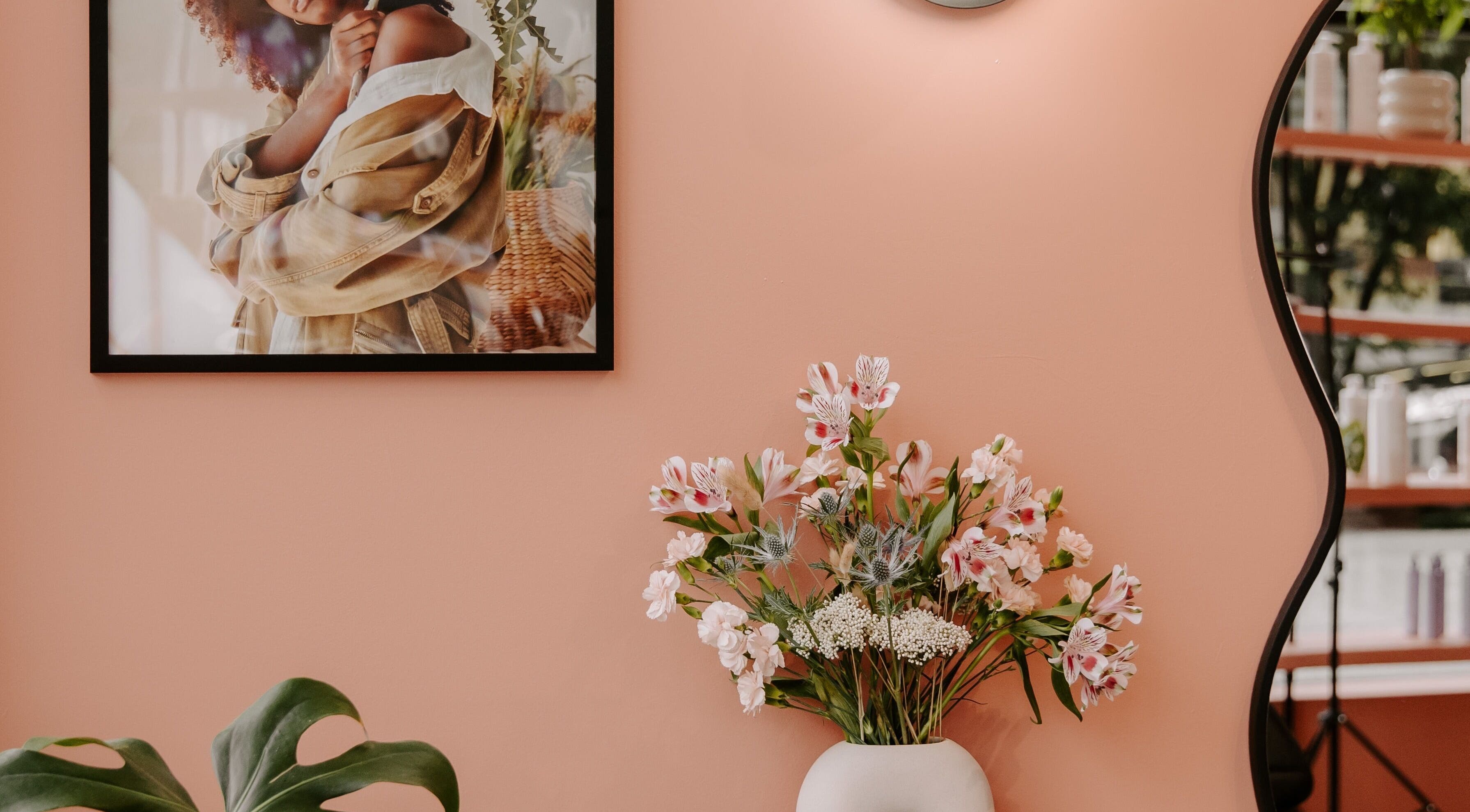 Stylish interior of LGHTTouch Pop-Up at Wash~Day, Philadelphia, PA, featuring a floral arrangement and framed art.