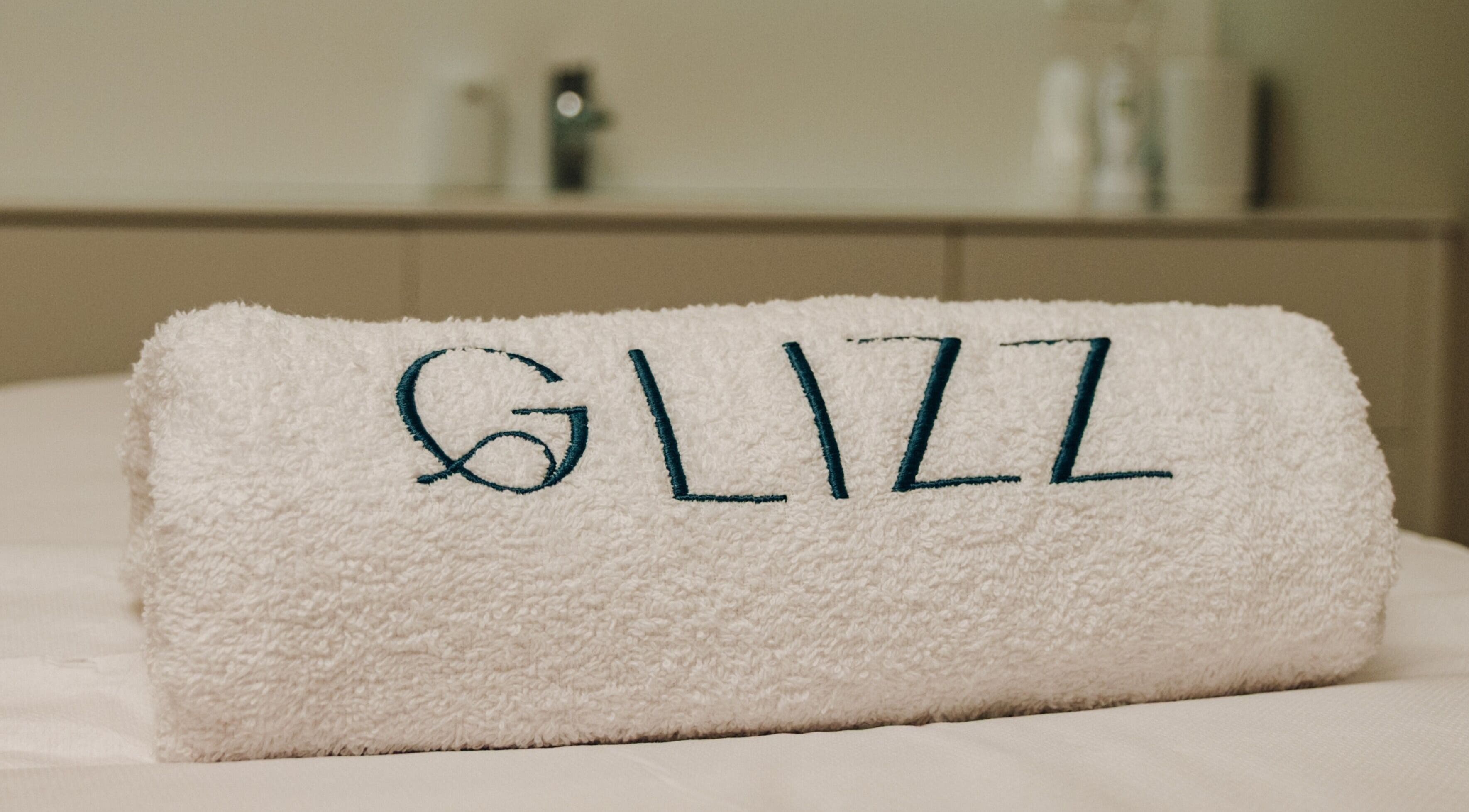 Wit handdoek met GLIZZ logo bij GLIZZ Genk in Genk, Vlaanderen, BE.