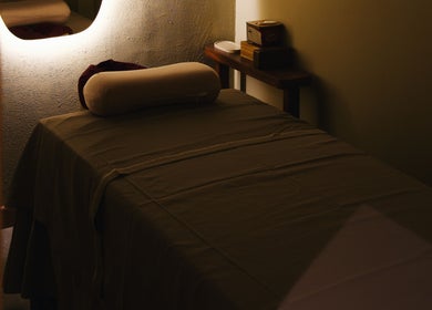 Peaceful massage room at The Zen Den Massage & Beauty Bali, Bali, ID, featuring a cozy massage table.