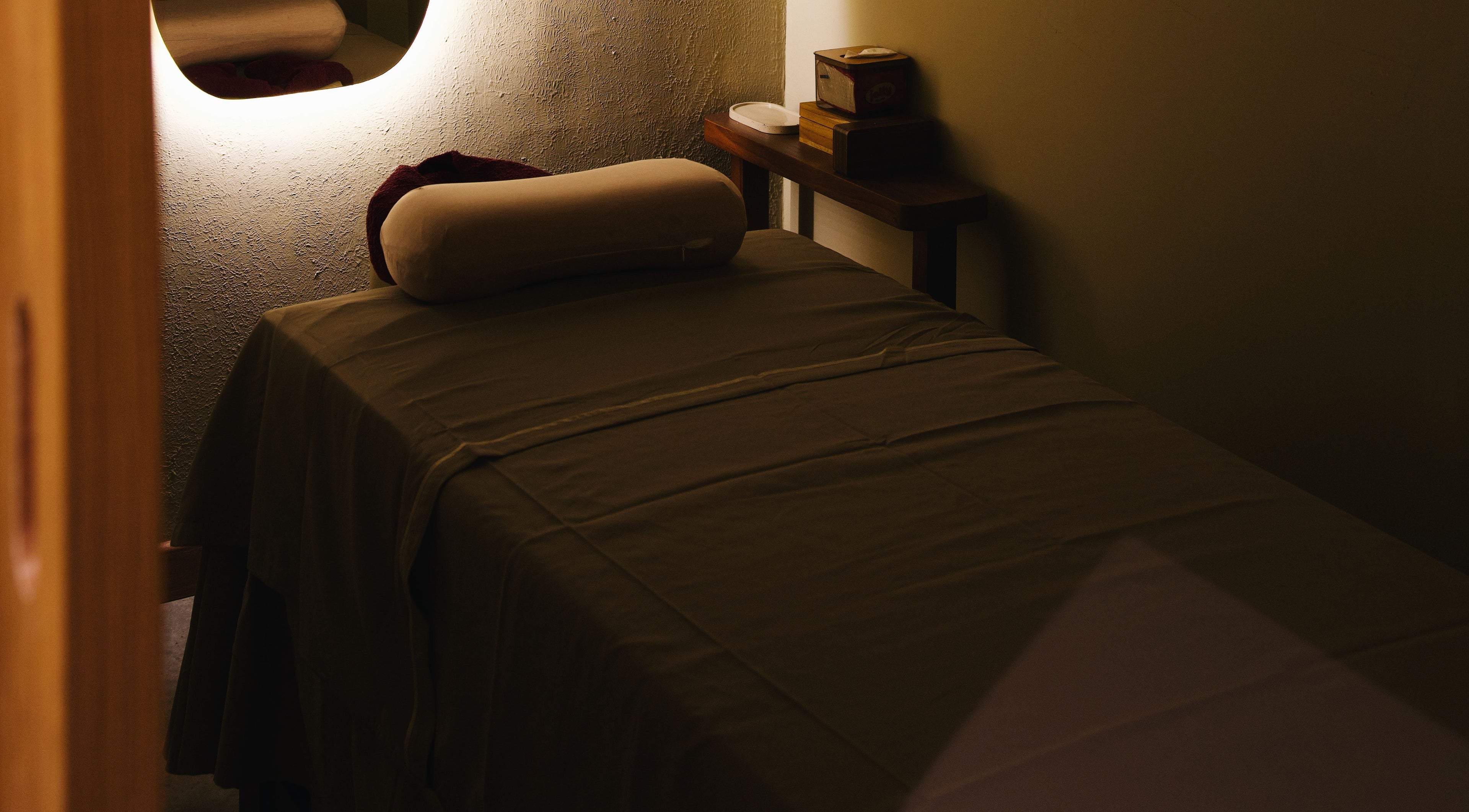 Peaceful massage room at The Zen Den Massage & Beauty Bali, Bali, ID, featuring a cozy massage table.