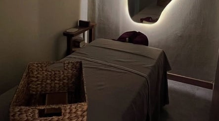 Tranquil massage room at The Zen Den Massage & Beauty Bali, Bali, ID with soothing ambient lighting.