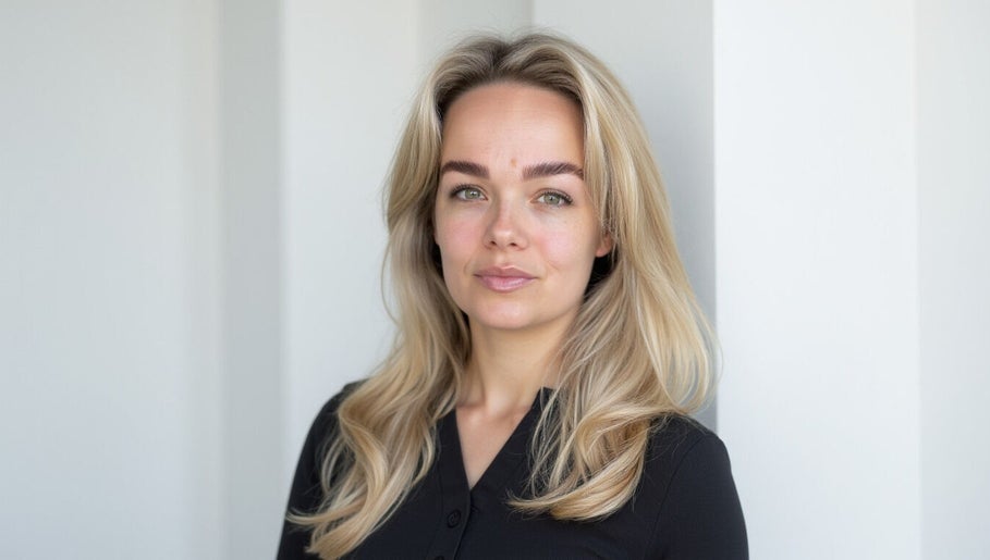 Smiling professional at SMP Aesthetics Kent, Royal Tunbridge Wells, England, GB, highlighting natural beauty.